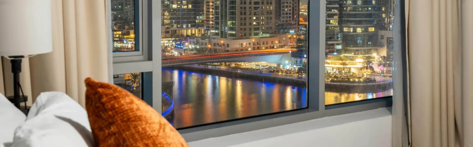 Dubai Marina night view from a bedroom window in shared accommodation in Dubai.