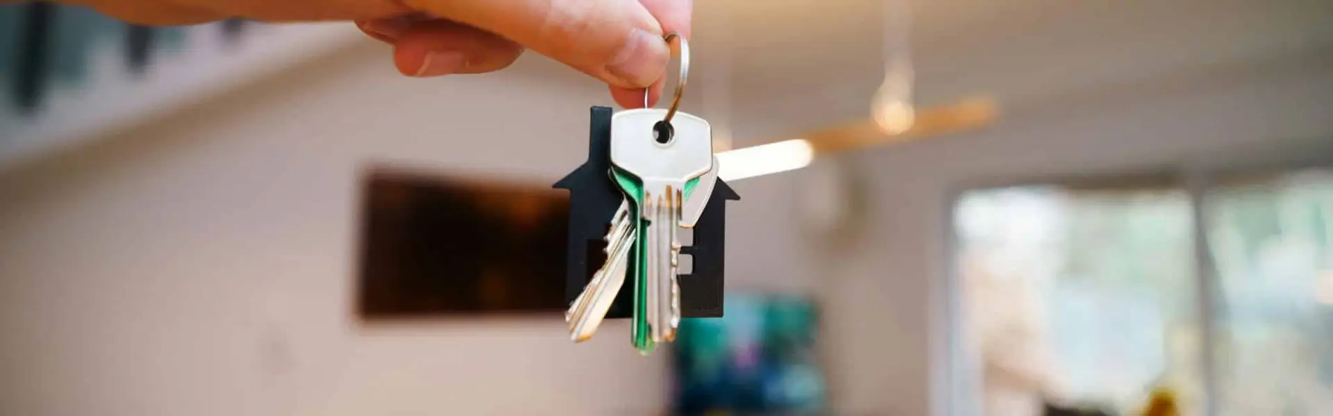 Hand holding house keys a practical first step in securing room rental in Dubai in 2025.