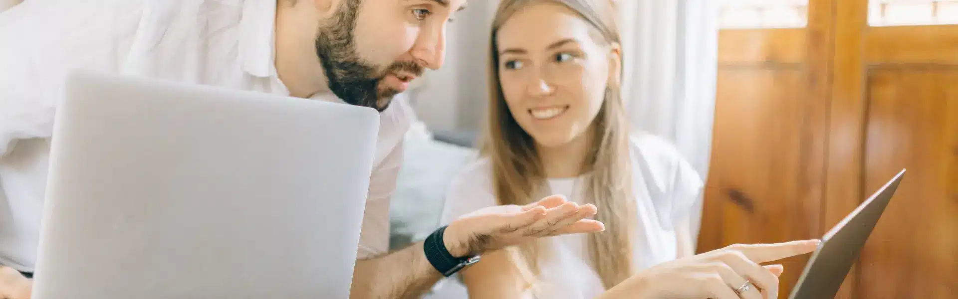 Person reviewing a room listing on a laptop in a Dubai apartment, researching is flat sharing is legal in Dubai